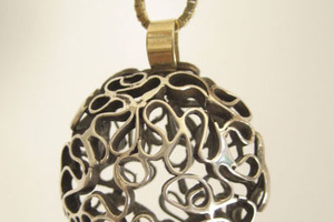 Hand made silver lace pendant with 14K gold accent.
