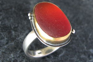 Red sea glass ring with gold bezel.
